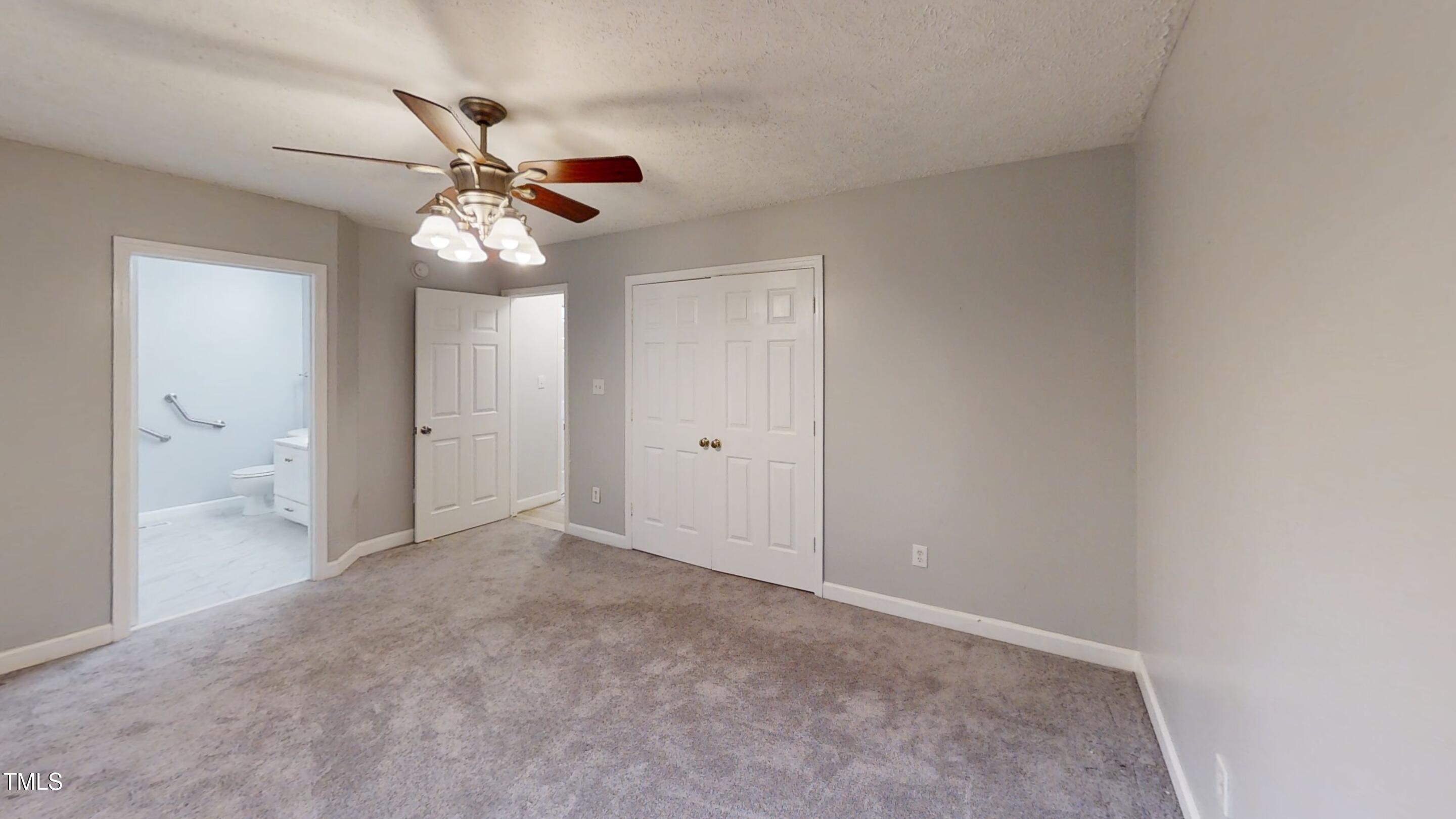 1420 East Lane Street Raleigh, NC 27610 - Photo 12 of 26 an empty room with a fan and a fan