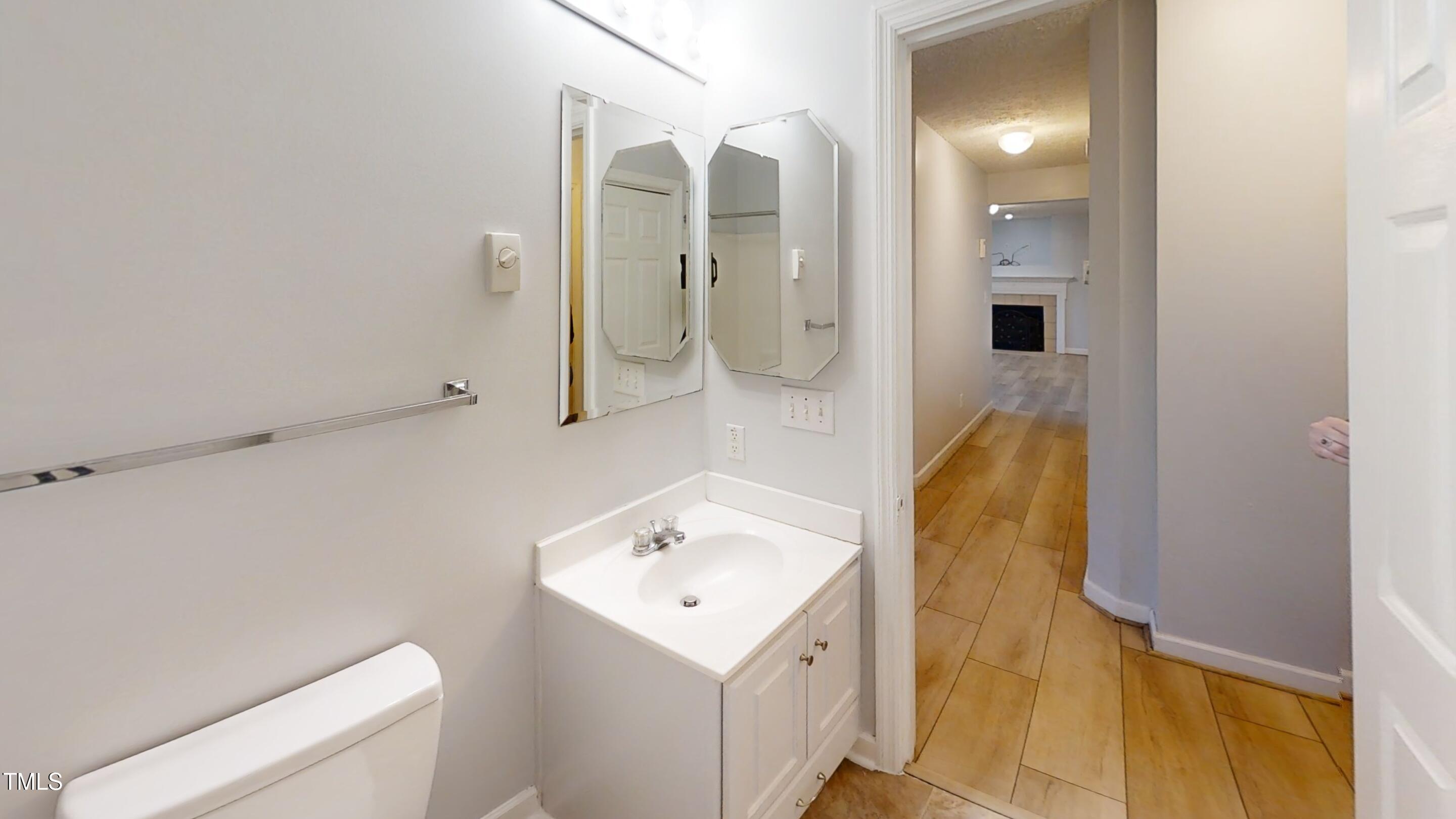 1420 East Lane Street Raleigh, NC 27610 - Photo 18 of 26 a bathroom with a sink and mirror with shower