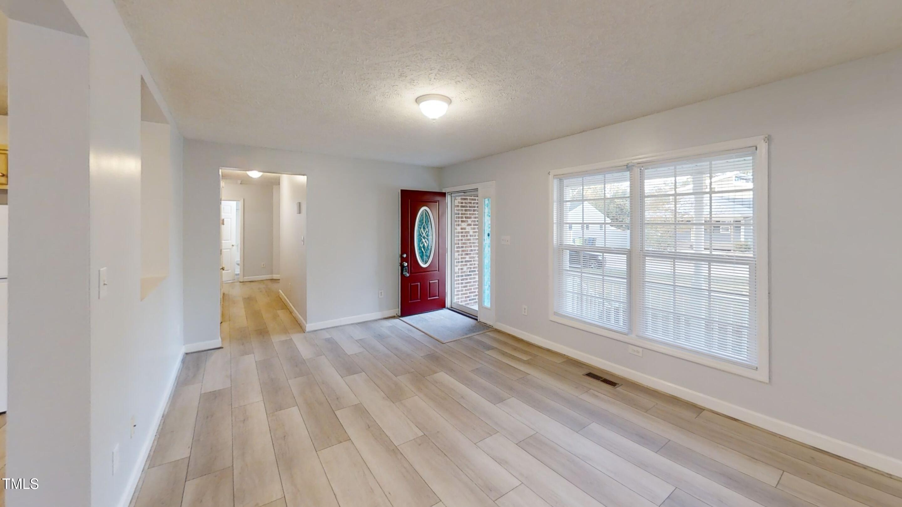 1420 East Lane Street Raleigh, NC 27610 - Photo 6 of 26 a view of empty room with wooden floor and fan