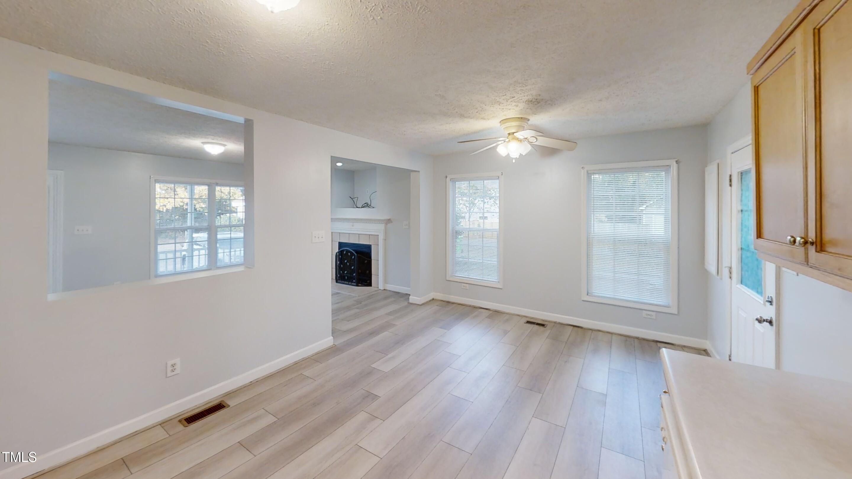1420 East Lane Street Raleigh, NC 27610 - Photo 7 of 26 wooden floor in an empty room with a window