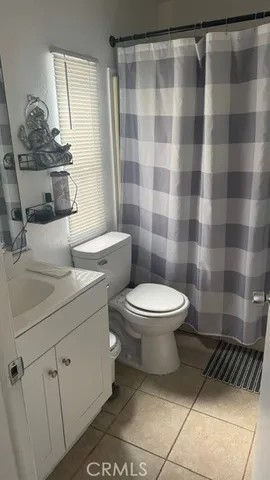 a bathroom with a toilet a sink and a shower