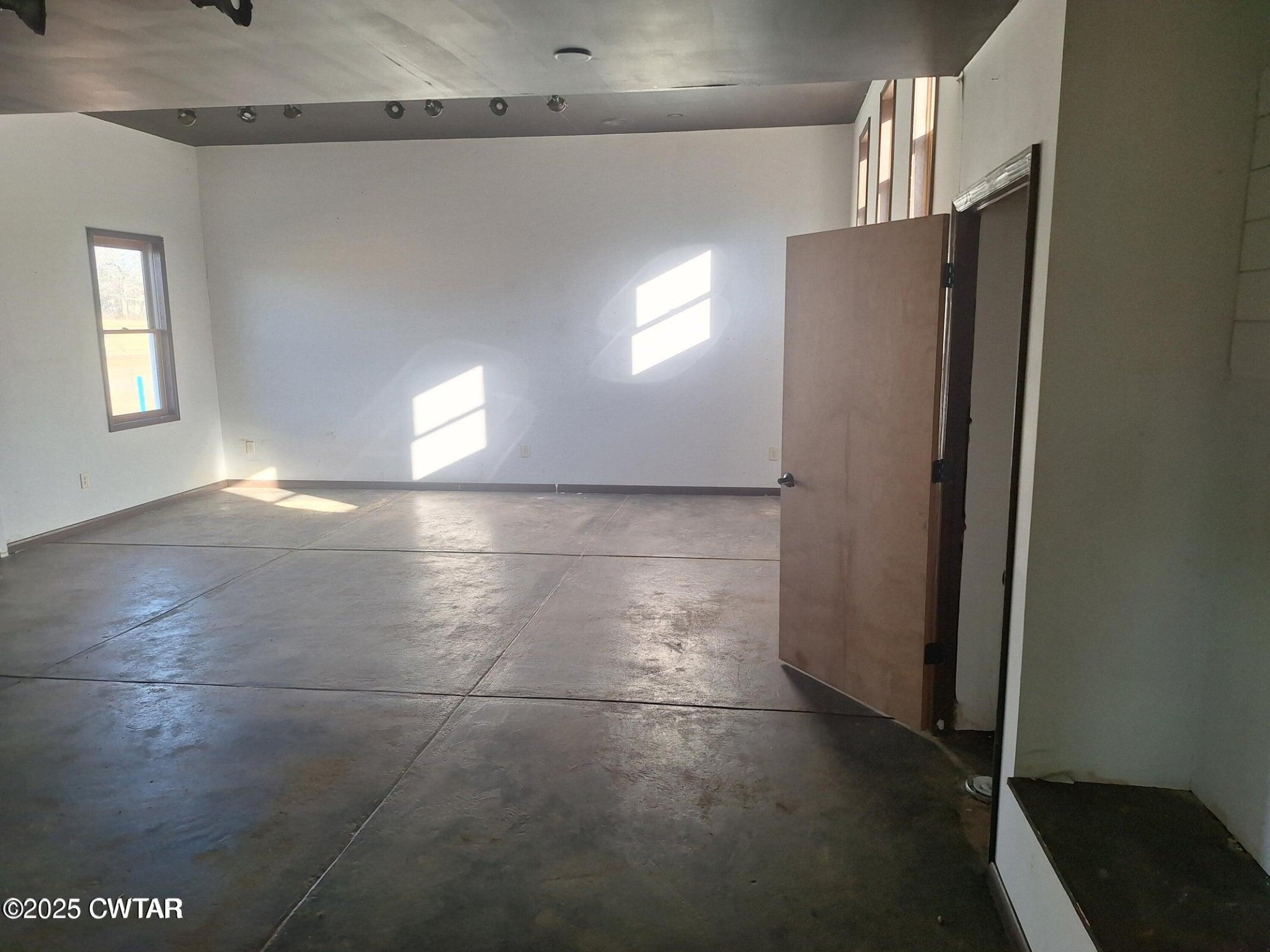 600 Highway 64 Adamsville, TN 38310 - Photo 14 of 25 a view of a refrigerator in kitchen and an empty room