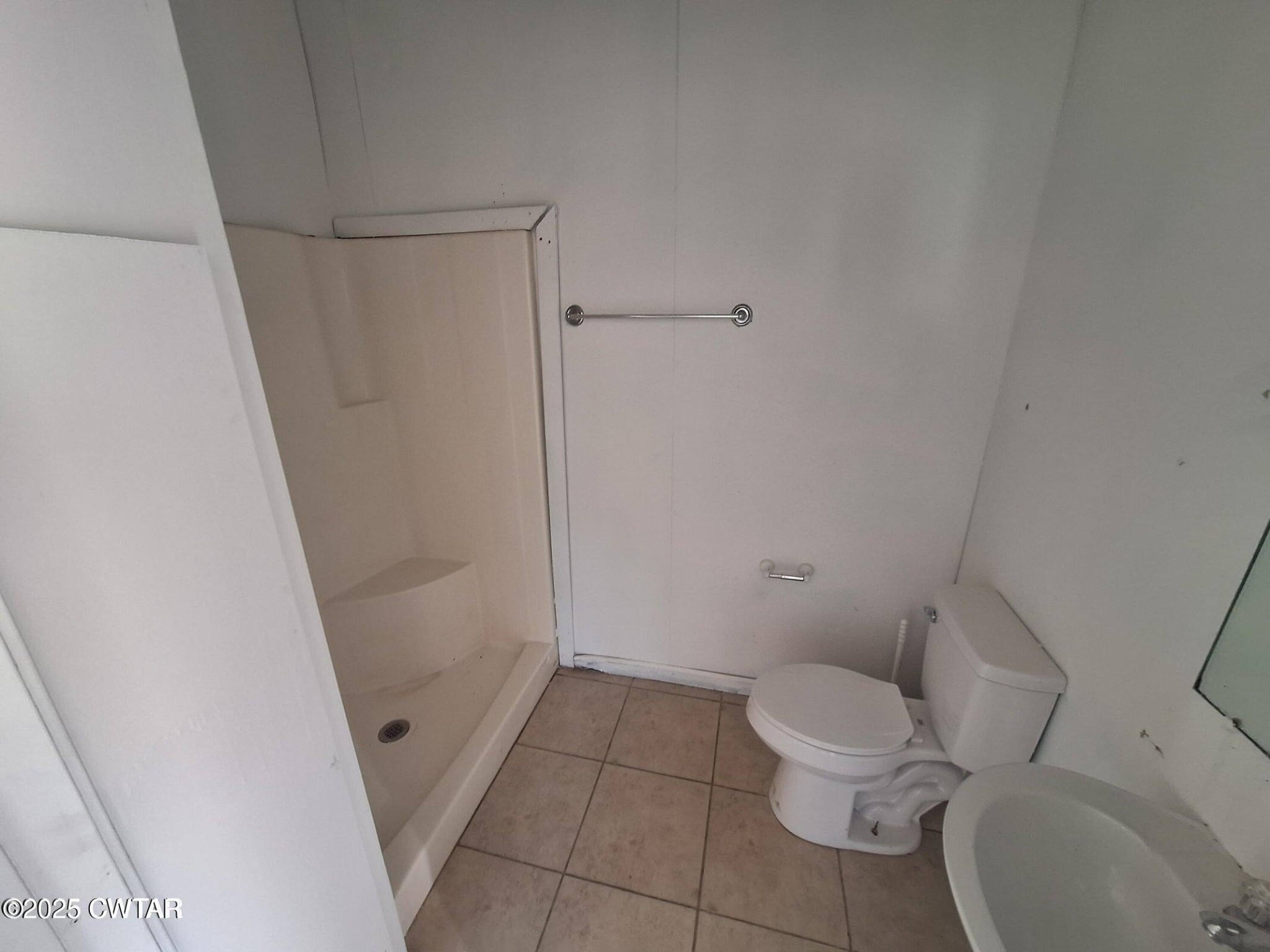 600 Highway 64 Adamsville, TN 38310 - Photo 15 of 25 a white toilet sitting next to a shower