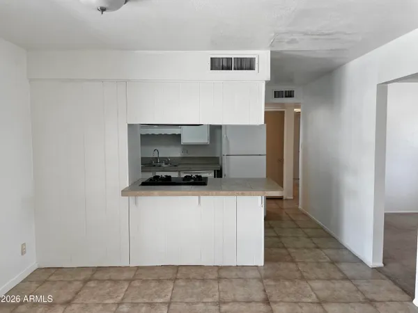a kitchen with stainless steel appliances a sink stove and cabinets