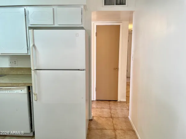 a view of storage and utility room with a refrigerator