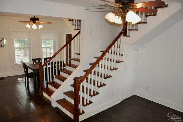 a view of entryway and hall with wooden floor