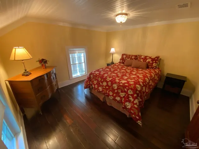 a bedroom with a bed and window with lamp