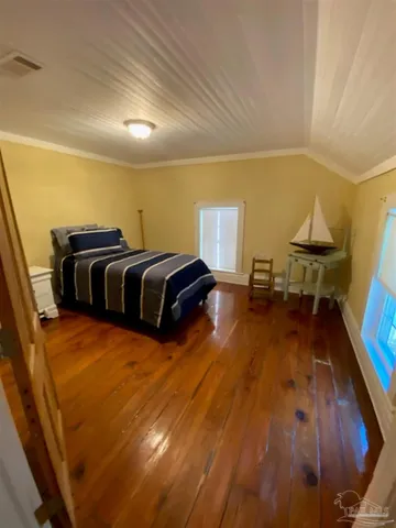 a bedroom with a bed and painted walls