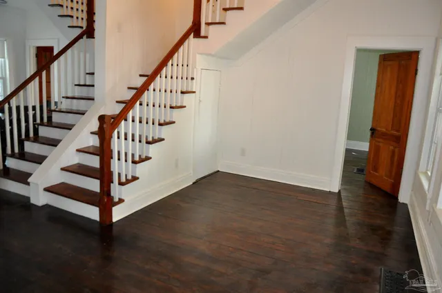 a view of entryway with wooden floor and stairs