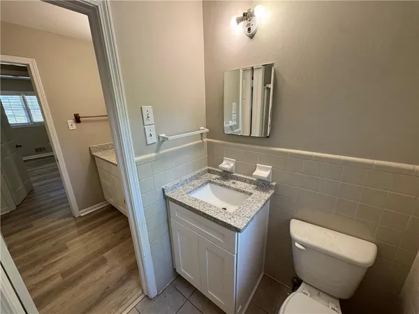 a bathroom with a toilet sink and mirror