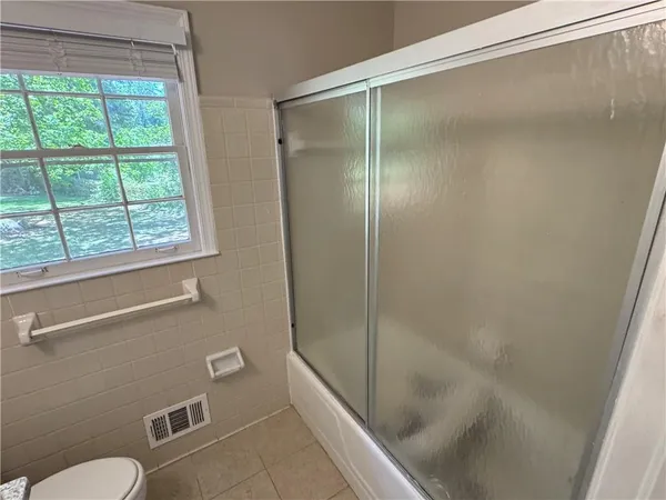 a bathroom with a shower and a toilet