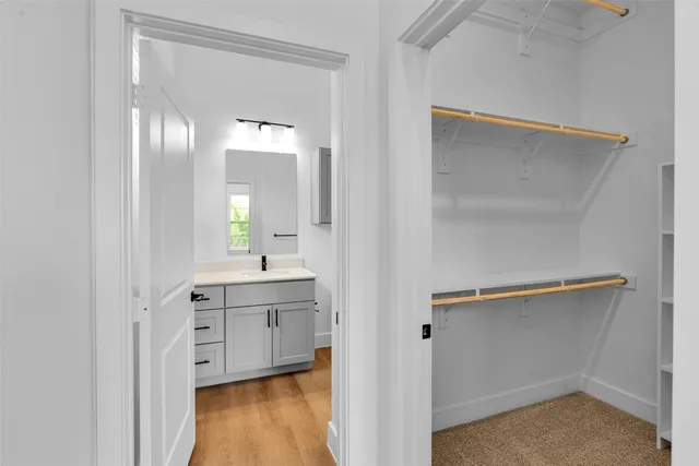 a en suite bathroom with a sink mirror and vanity