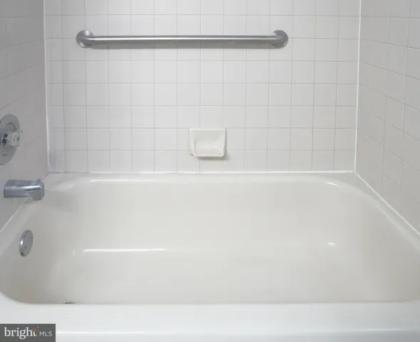 a white toilet sitting next to a shower