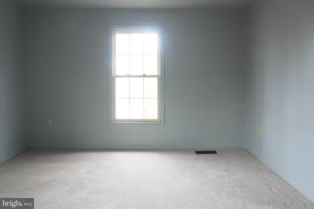 an empty room with closet and a bathroom