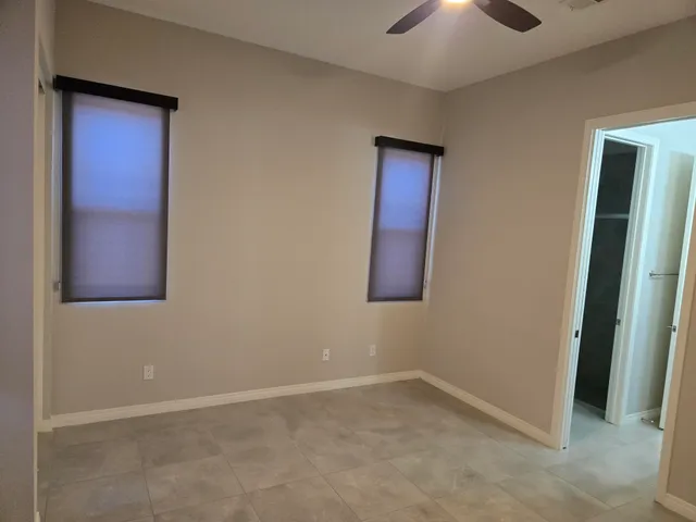 an empty room with mirror and entrance