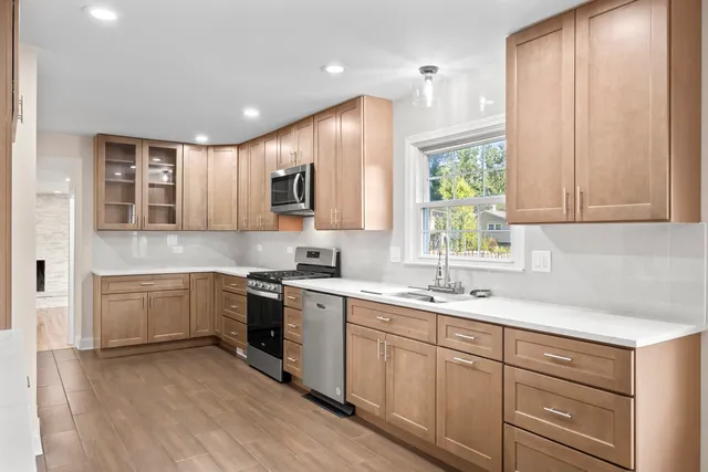 a kitchen with a sink cabinets and window