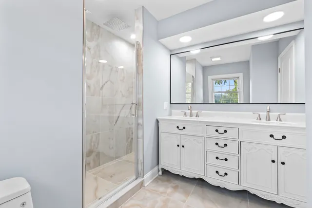 a bathroom with a double vanity sink mirror and double