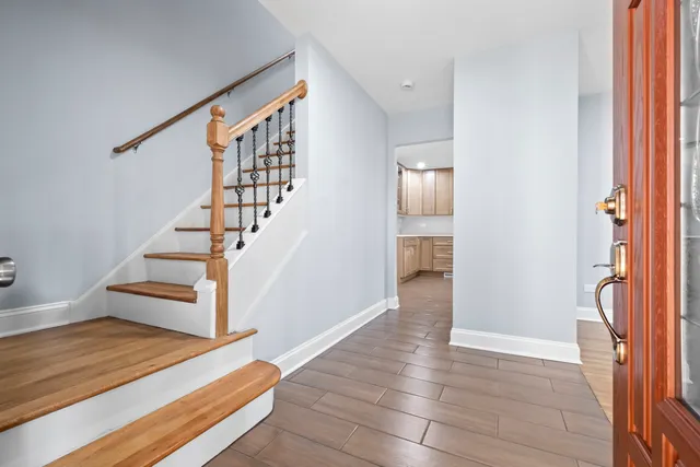 a view of entryway and hall with wooden floor
