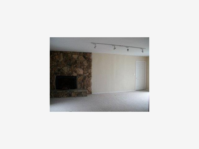 873 Ocean Boulevard Moss Beach, CA 94038 - Photo 2 of 9 a living room with a chair and a fireplace