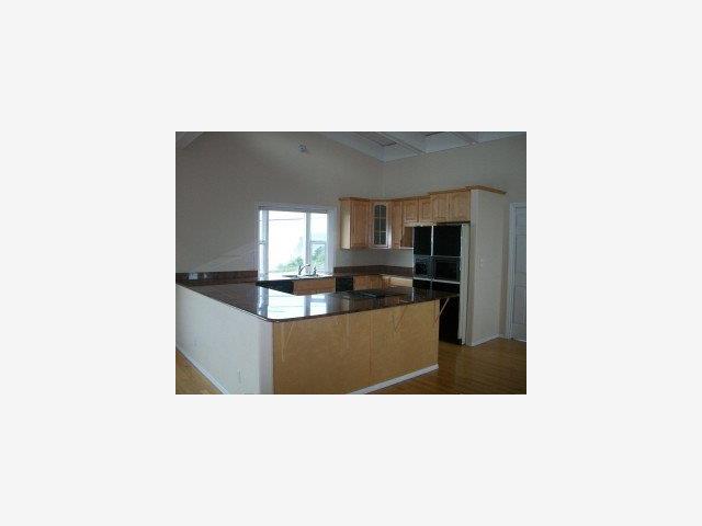 873 Ocean Boulevard Moss Beach, CA 94038 - Photo 8 of 9 a kitchen with kitchen island sink and refrigerator