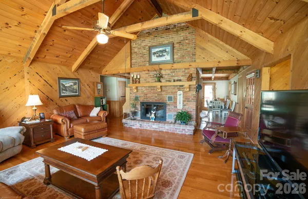 a dining hall with stainless steel appliances kitchen island granite countertop a refrigerator a stove and a dining table with large windows