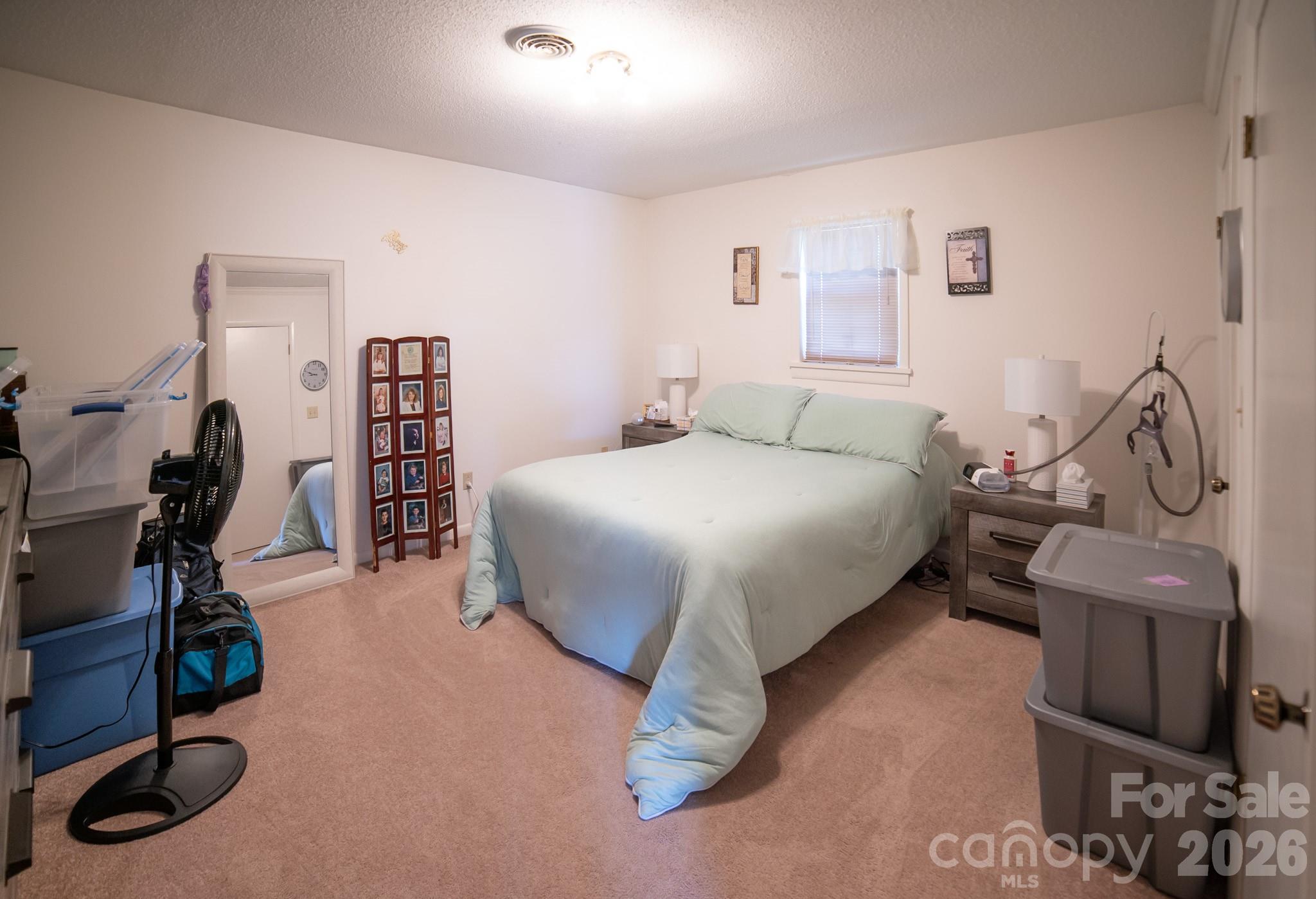 1368 Cajah Mountain Road Hudson, NC 28638 - Photo 32 of 39 a bedroom with a bed and gym equipment