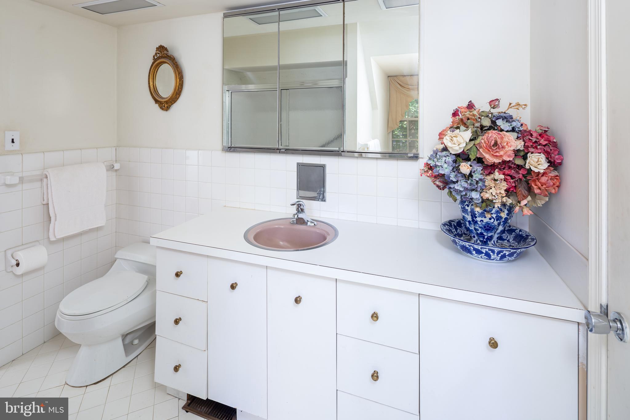 8 Fox Chase Road Malvern, PA 19355 - Photo 35 of 49 a bathroom with a sink a toilet and a mirror