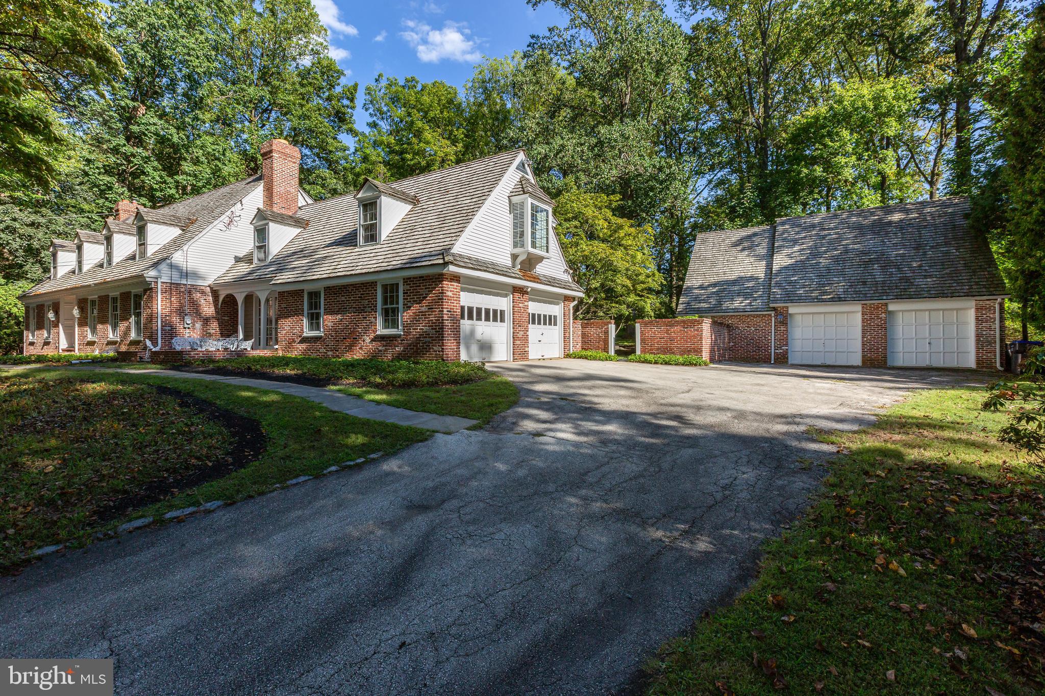 8 Fox Chase Road Malvern, PA 19355 - Photo 4 of 49 a view of a white house next to a yard with big trees