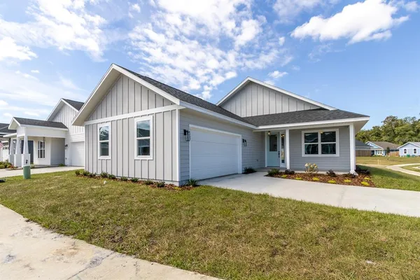 a front view of a house with a yard and porch