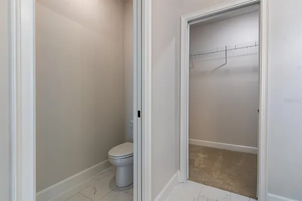 a bathroom with a granite countertop toilet
