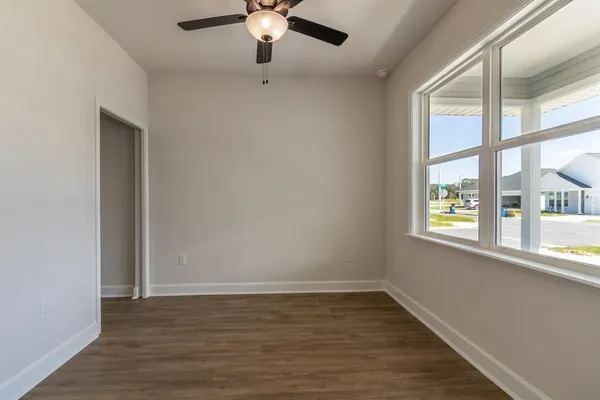 wooden floor in an empty room with a window