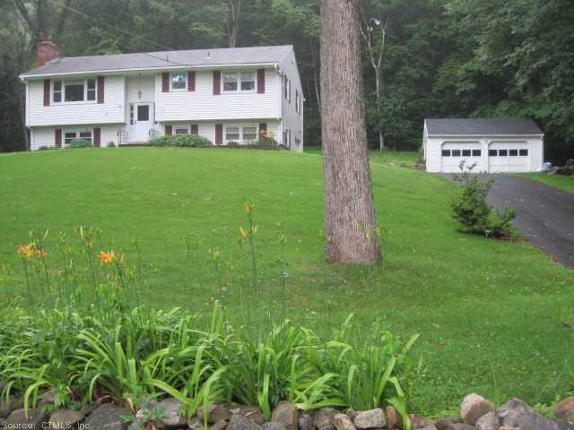 a view of a house with a backyard