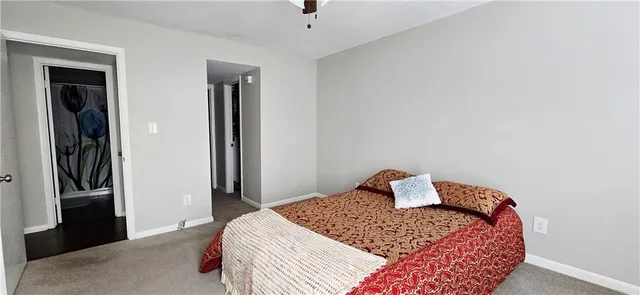 a bedroom with a bed and lamp