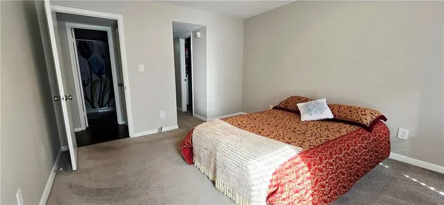 a bedroom with a bed and a mirror