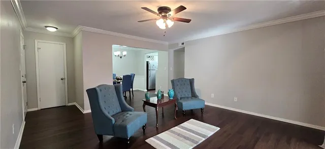 a view of a workspace with furniture and wooden floor