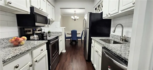 a kitchen with a sink stove and refrigerator