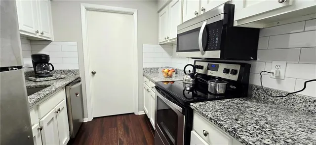 a kitchen with a sink stove and refrigerator