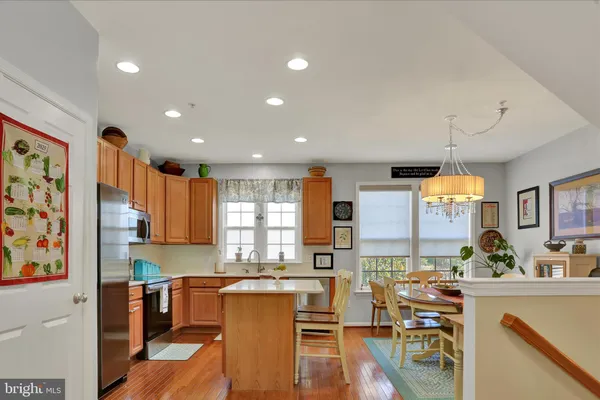 a living room with stainless steel appliances kitchen island granite countertop furniture and a kitchen view