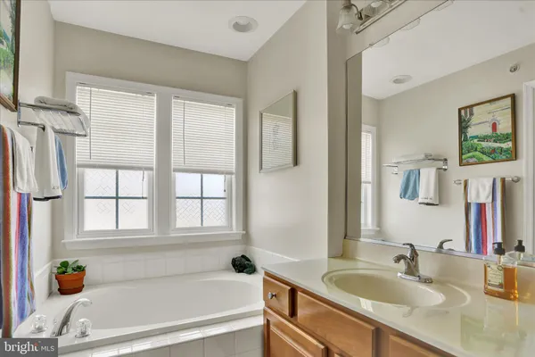 a bathroom with a sink a toilet and a view of bathroom