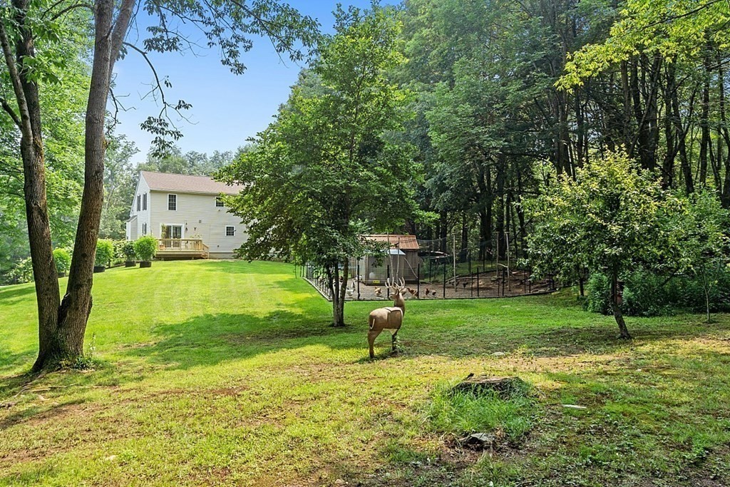 454 Loring Road Barre, MA 01005 - Photo 26 of 42 a view of a house with a backyard and a tree