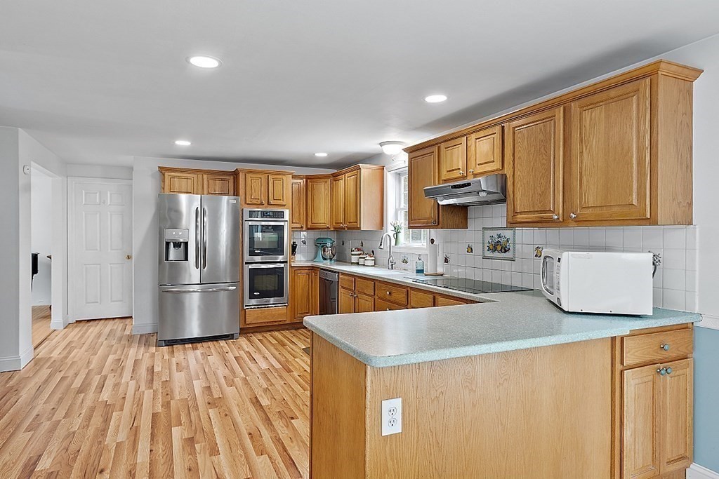 454 Loring Road Barre, MA 01005 - Photo 8 of 42 a kitchen with stainless steel appliances granite countertop a refrigerator a sink dishwasher a stove with wooden cabinets and floor