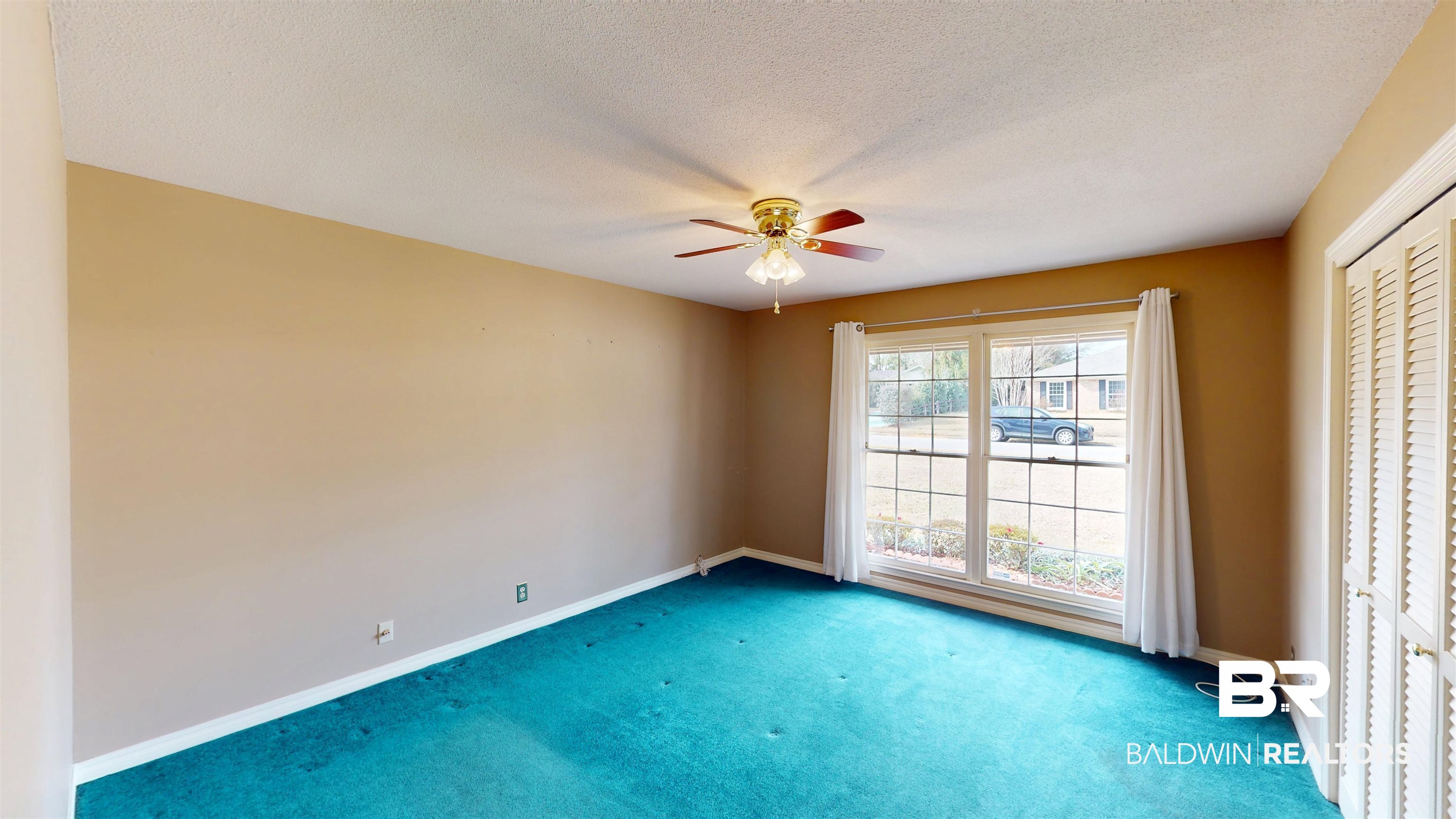 609 Burlington Court Mobile, AL 36608 - Photo 15 of 19 Empty room featuring carpet, a ceiling fan, and a textured ceiling