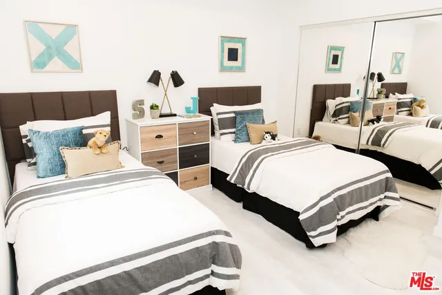 a bedroom with two beds and painted walls