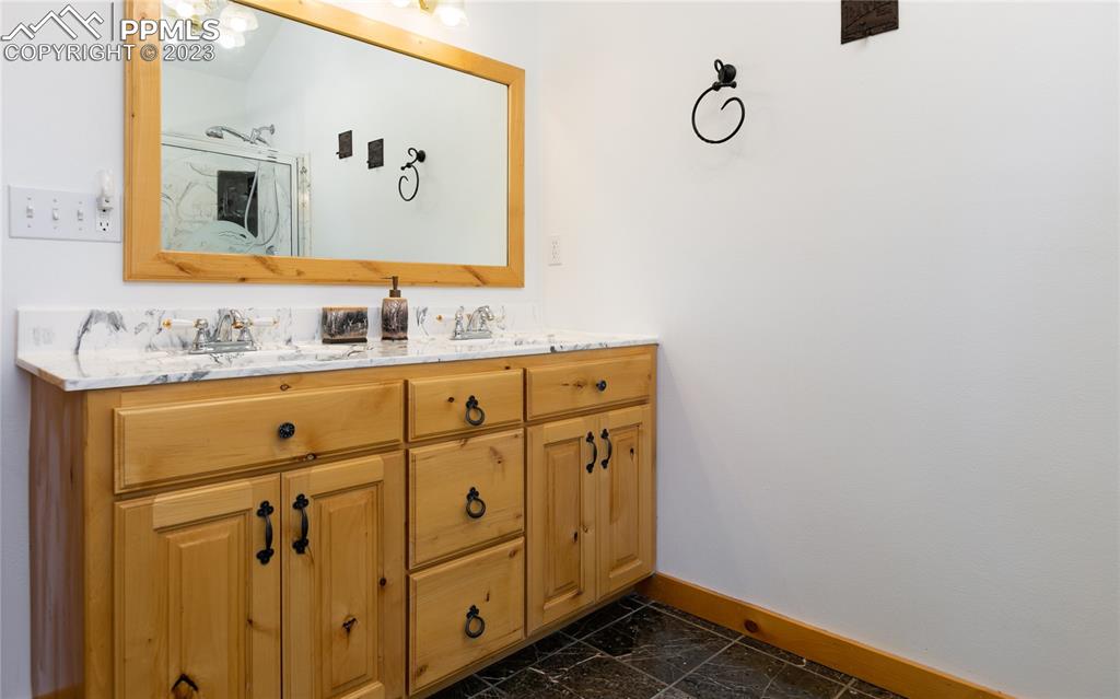 1321 Bristlecone Road Guffey, CO 80820 - Photo 18 of 37 a bathroom with a sink mirror and vanity