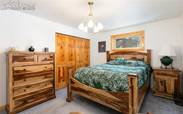 a bedroom with a bed and a chandelier