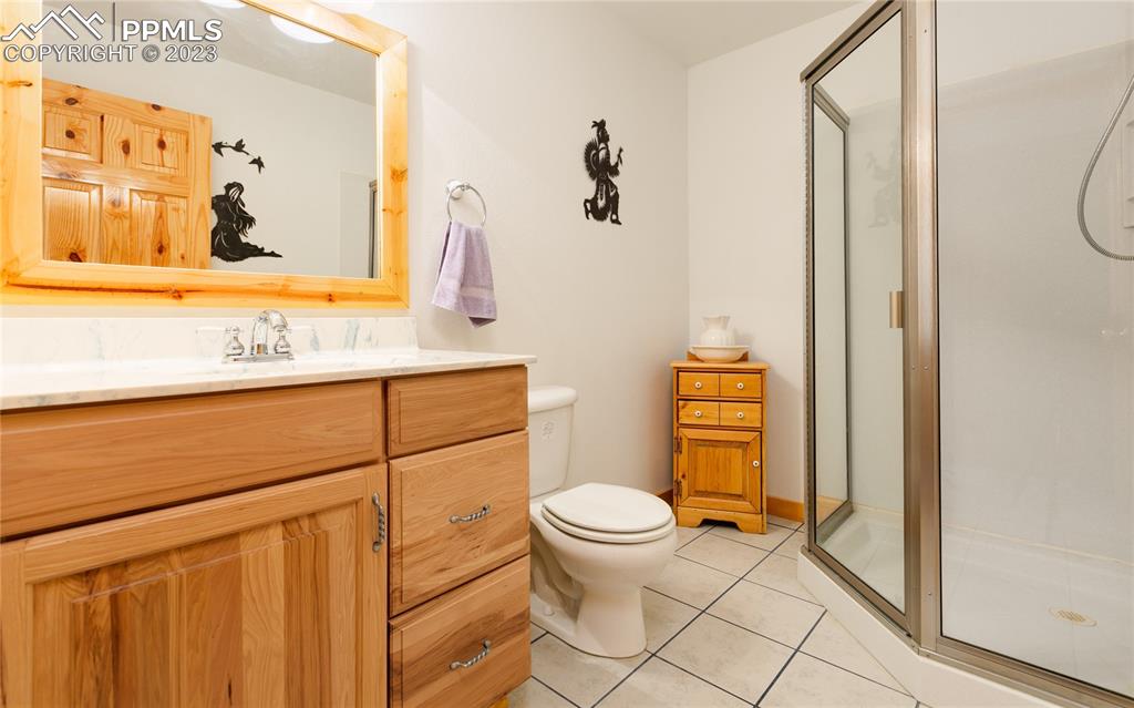 1321 Bristlecone Road Guffey, CO 80820 - Photo 27 of 37 a bathroom with a granite countertop toilet sink and mirror