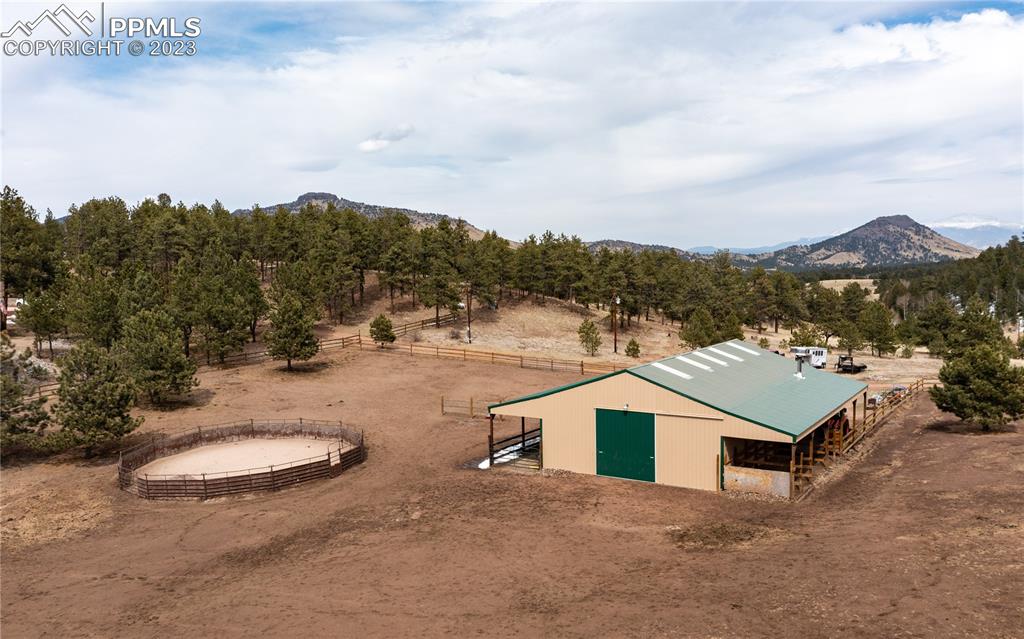 1321 Bristlecone Road Guffey, CO 80820 - Photo 34 of 37 a view of a white house with a yard and roof