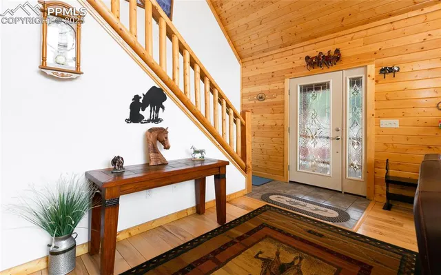 a view of an entryway with wooden floor and front door