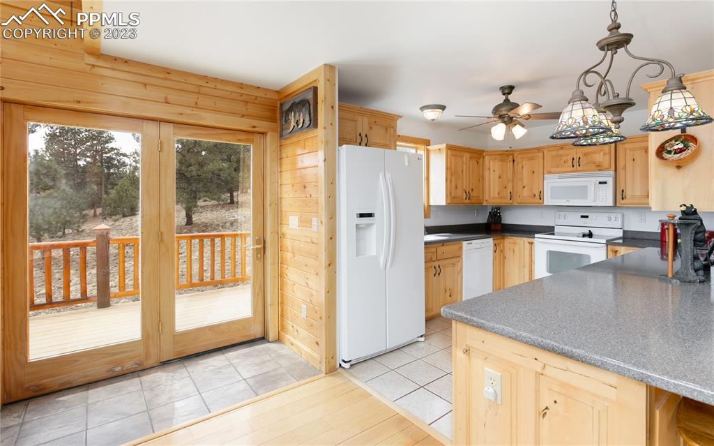 1321 Bristlecone Road Guffey, CO 80820 - Photo 9 of 37 a kitchen with granite countertop a refrigerator and a stove top oven