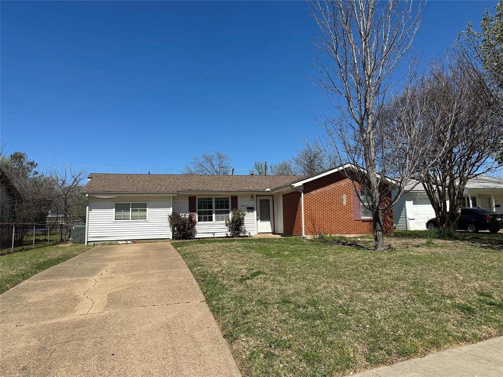2203 Finley Road Irving, TX 75062 - Photo 1 of 1 a front view of a house with a yard